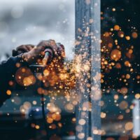 A construction worker using a grinder