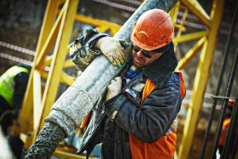 Man working with cement hose