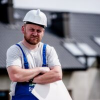 Construction worker frowns on the job.