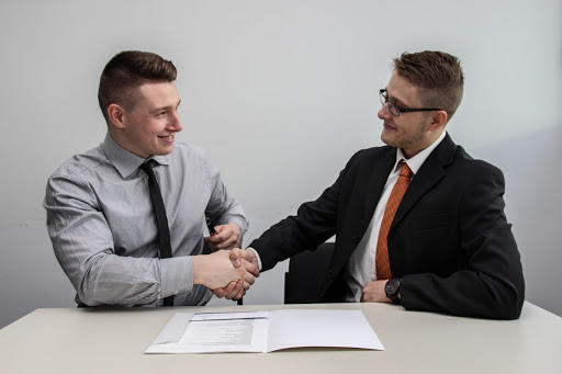 Men shaking hands over contract