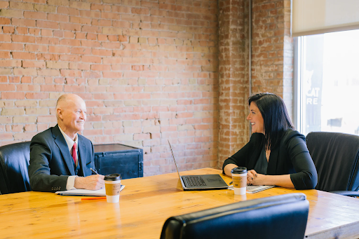 Professional business people conversing in a meeting room.