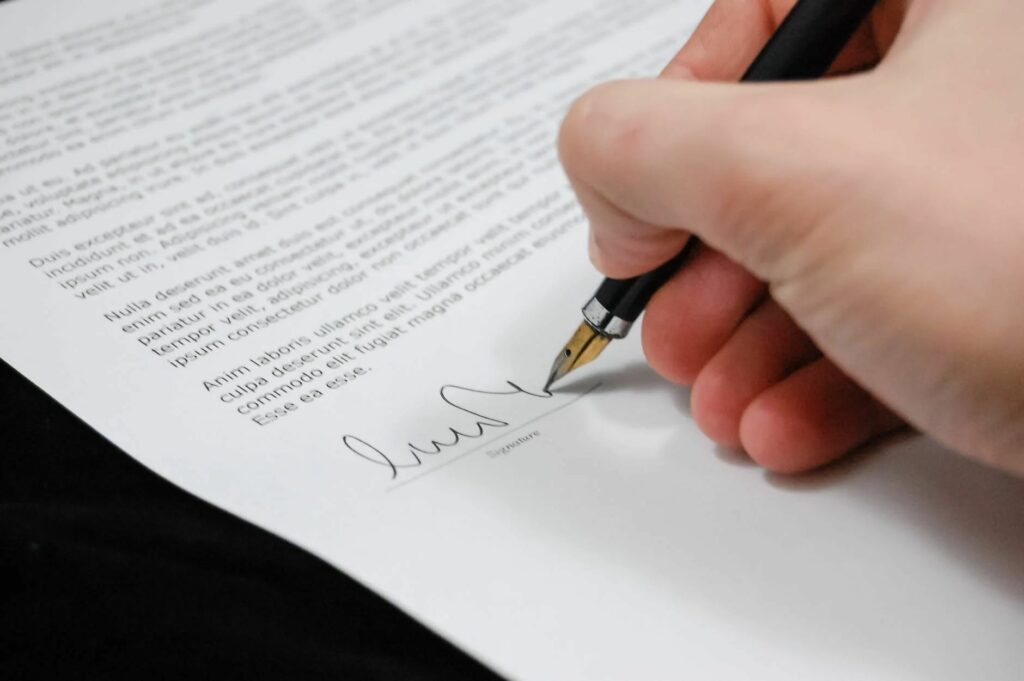 A person signing a document 