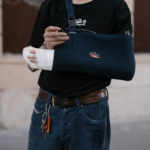 Person with Blue Bandage on his Injured Arm