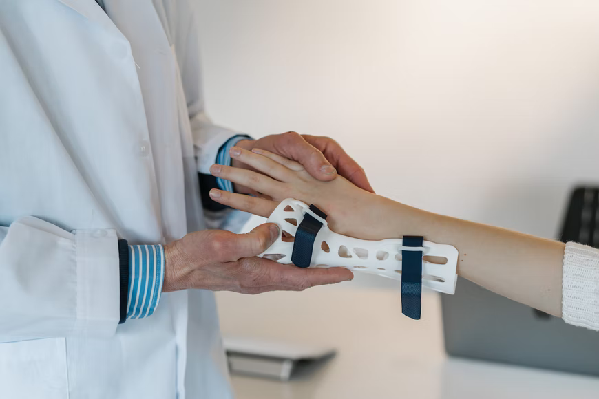 A doctor putting a cast on someone’s arm.