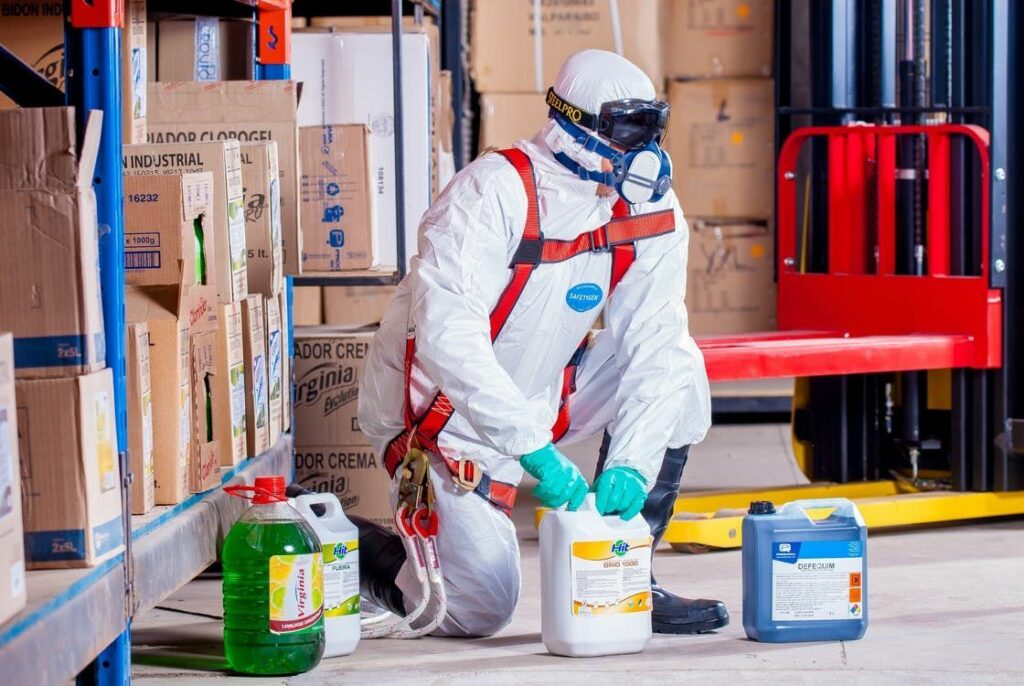 A warehouse employee handling hazardous chemicals 