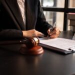 Lawyer working with legal case document contract and wooden gavel