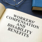 Open Workers Compensation and Disability Benefits law book.