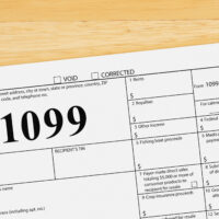 Federal tax 1099 form on a wood desk