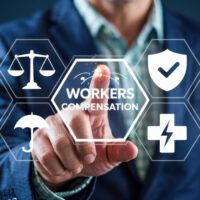 Businessperson interacts with workers' compensation interface.