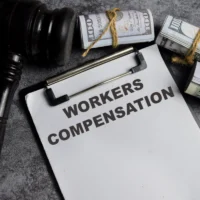concept-of-workers-compensation-write-on-paperwork-isolated-on-wooden-table concept-of-workers-compensation-write-on-paperwork-isolated-on-wooden-table